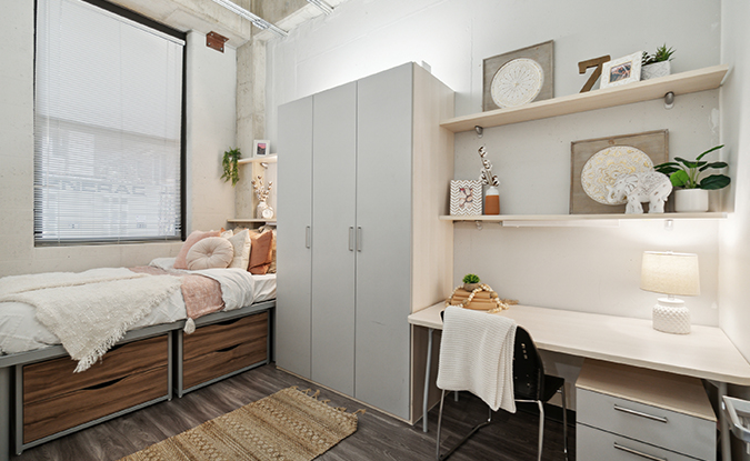 Furnished apartment bedroom with a large window
